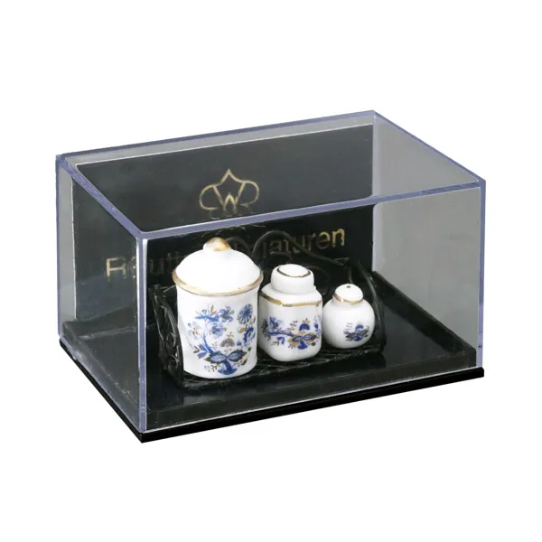 Kitchen shelf with various porcelain tins, gold onion